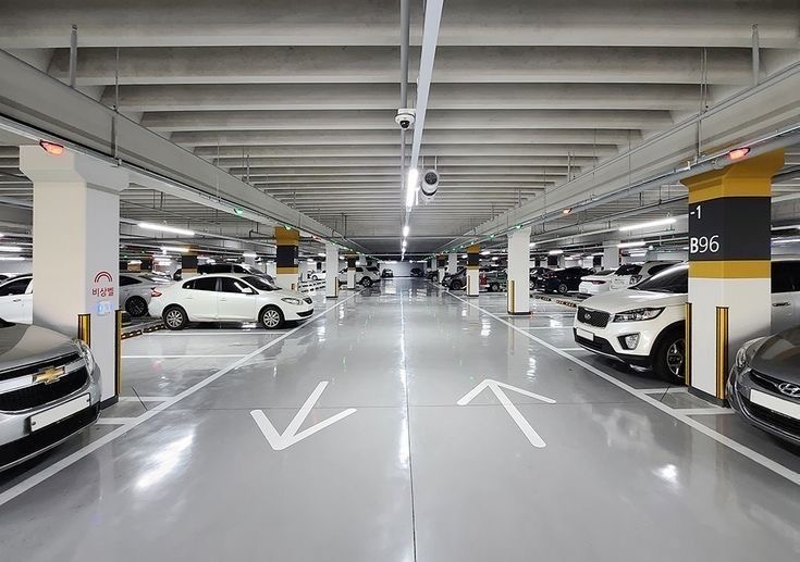 Bright covered basement parking with marked bays
